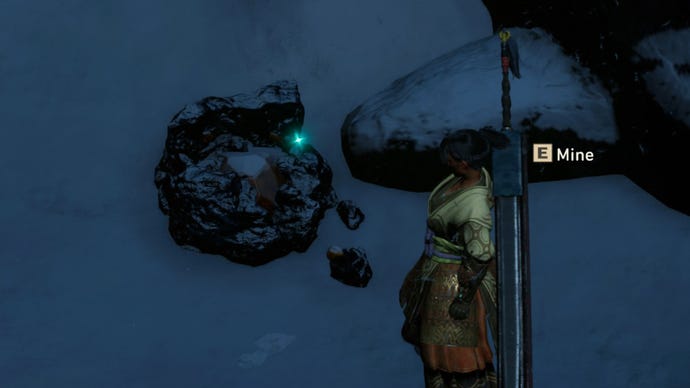 The player in Wild Hearts stands next to some Lightstone on a snowy cliff.