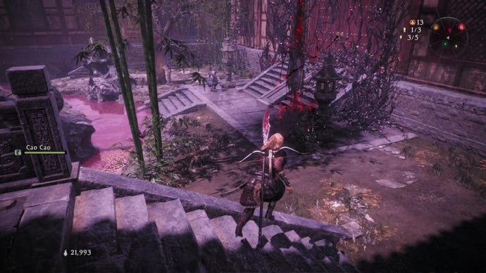 A Wo Long: Fallen Dynasty screenshot of the player standing next to a flag.