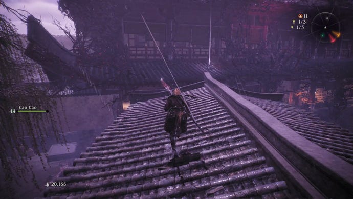 A Wo Long: Fallen Dynasty screenshot of the player standing next to a flag.