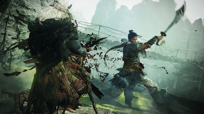 The player strikes an enemy with a glaive in Wo Long: Fallen Dynasty.