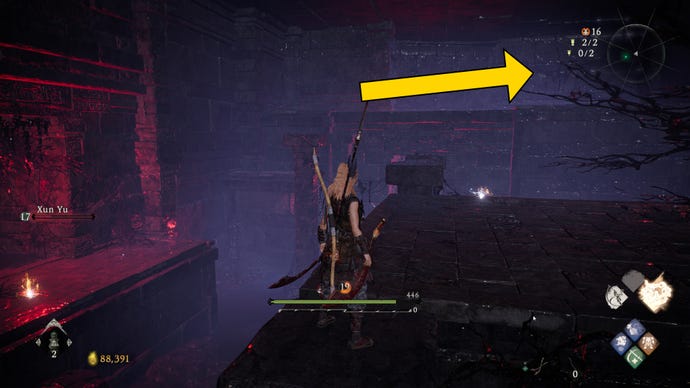 The player in Wo Long stands atop a raised platform in the centre of an underground room. An arrow points to the location of a nearby Shitieshou.