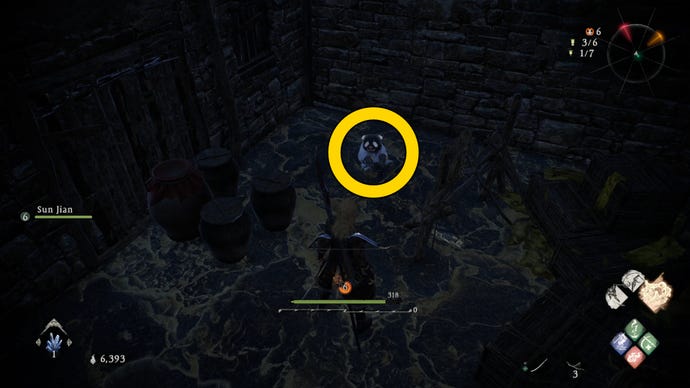 The player in Wo Long finds a Shitieshou in a darkened room filled with boxes.