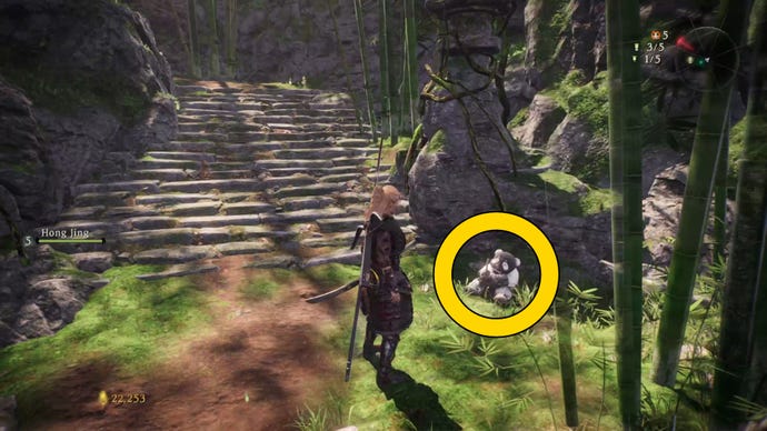 The player in Wo Long stands next to a Shitieshou demon in a bamboo forest.