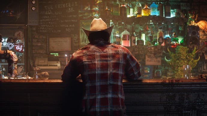 The back of Wolverine from the announcement teaser for Insomniac's upcoming Wolverine game. He is sitting at a bar and wearing a red plaid shirt and cowboy hat
