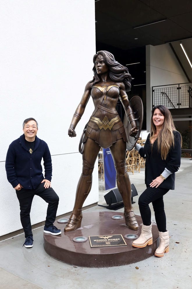 Jim Lee and Patty Jenkins next to Wonder Woman statue