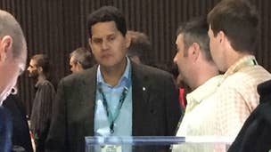 Let's enjoy this incredible photo of Nintendo's Reggie Fils-Aime looking at the Xbox S