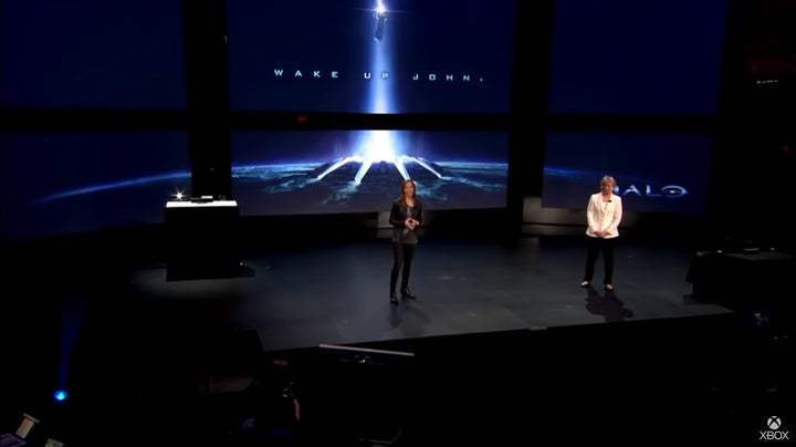 Bonnie Ross and Nancy Tellem on stage at the Xbox One reveal. On the screen behind them is an image from the Halo TV show with the words &quot;Wake up John&quot;