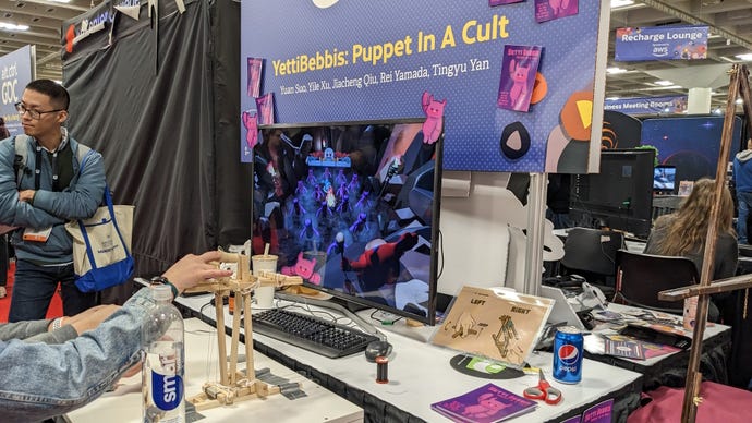 A player controls a game using an intricate wooden puppet frame at GDC