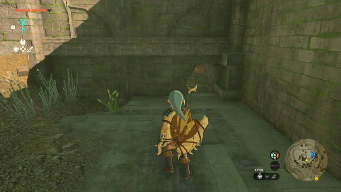 Link squeezing through a hole to get underneath the Akkala Citadel Bedchamber in Zelda: Tears of the Kingdom