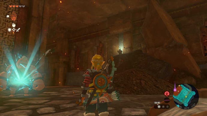 Zelda TOTK, Link is standing in front of a gong in the Fire Temple looking at a slanted stone pillar.