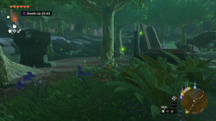 Link sneaking around in woods at night try to catch fireflies in The Legend of Zelda: Tears of the Kingdom.