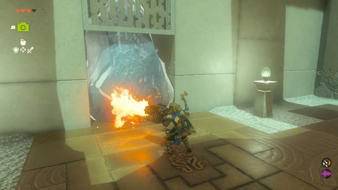 Zelda Tears of the Kingdom, Link using a flame emitting shield to melt a block of ice blocking a door