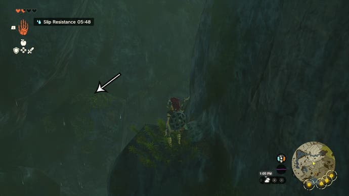 Link standing on a rock in the Ploymous Mountain Cave with an arrow pointing at another rock players need to glide towards.