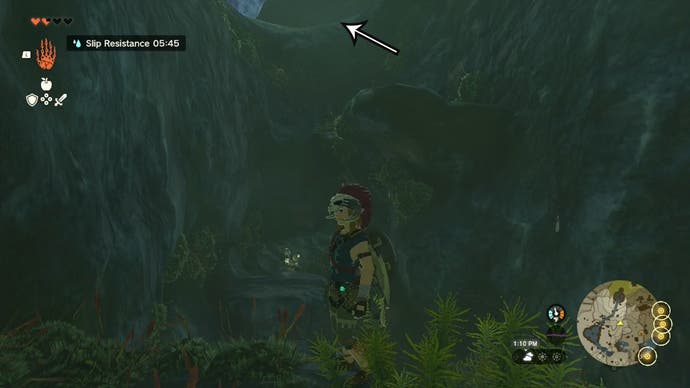 Link standing in the Ploymous Mountain Cave, with an arrow pointing in the direction players need to head to find the Climber’s Bandana.